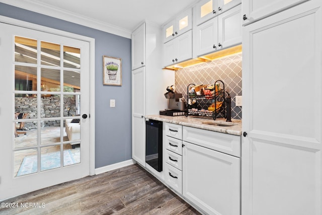 1491 Lanvale Rd NE, Leland, NC 28451 - bar featuring beverage cooler, decorative backsplash, ornamental molding, dark wood-style flooring, and a sink