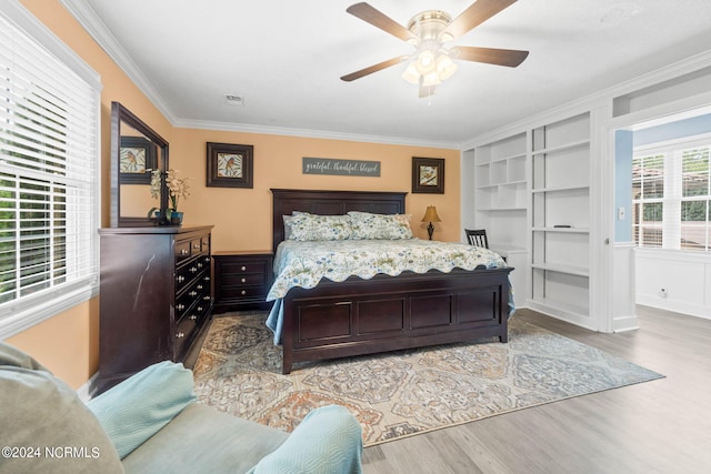 1491 Lanvale Rd NE, Leland, NC 28451 - bedroom featuring ornamental molding, wood finished floors, visible vents, and a ceiling fan