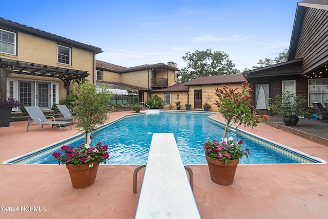 1491 Lanvale Rd NE, Leland, NC 28451 - pool featuring a diving board, a patio, french doors, and a pergola