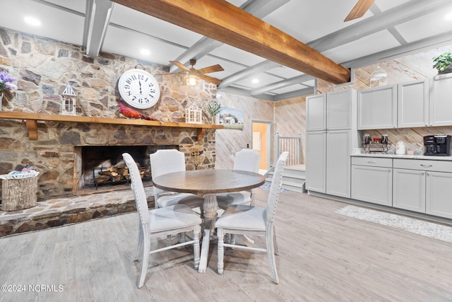 1491 Lanvale Rd NE, Leland, NC 28451 - dining space featuring beamed ceiling, ceiling fan, a stone fireplace, and light wood finished floors