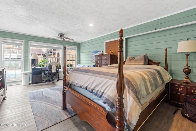 1491 Lanvale Rd NE, Leland, NC 28451 - bedroom featuring access to outside, a textured ceiling, and wood finished floors