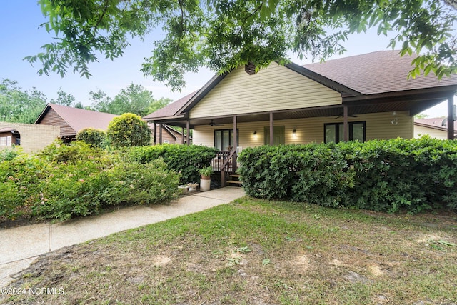1491 Lanvale Rd NE, Leland, NC 28451 - view of front of home with ceiling fan, a porch, and a shingled roof