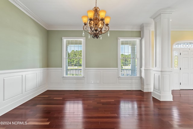 unfurnished dining area featuring ornamental molding, a healthy amount of sunlight, and an inviting chandelier