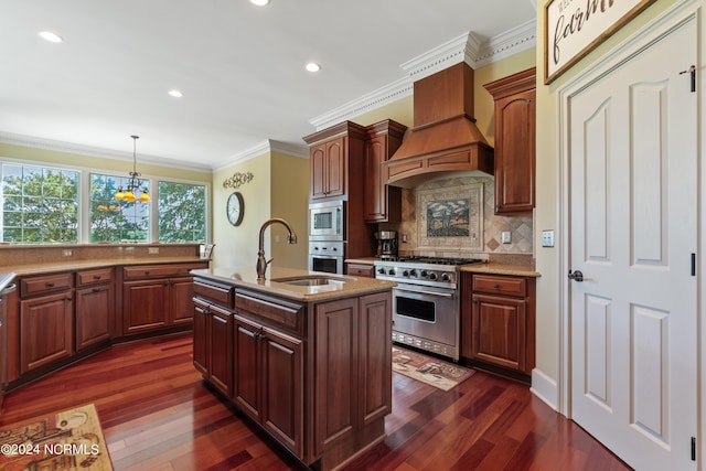 kitchen featuring an island with sink, pendant lighting, decorative backsplash, custom range hood, and appliances with stainless steel finishes