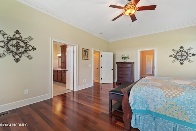 bedroom with wood finished floors, visible vents, baseboards, ornamental molding, and ensuite bath