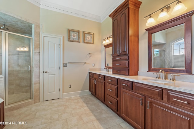 bathroom with vanity, a shower with shower door, and ornamental molding