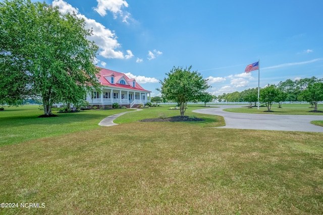 view of property's community with a yard and driveway