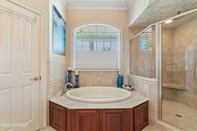 bathroom with ornamental molding, a stall shower, and a bath