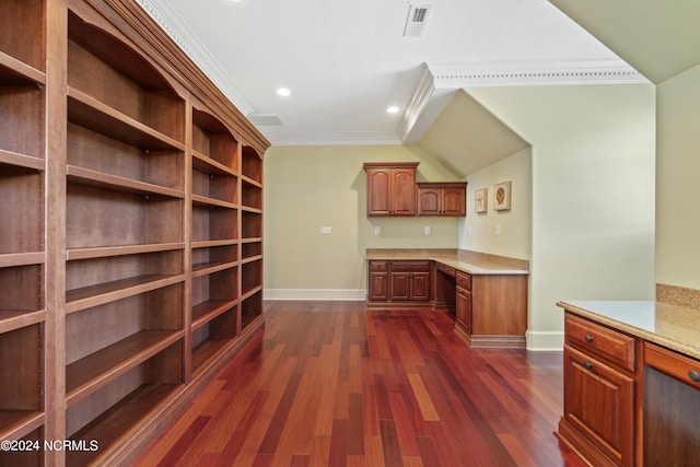 interior space featuring light stone counters, built in desk, crown molding, and dark wood-type flooring