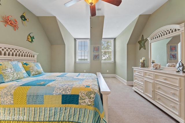 bedroom with light carpet, lofted ceiling, a ceiling fan, and baseboards