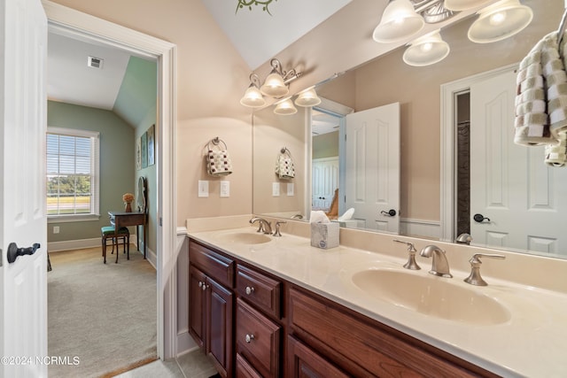 bathroom featuring vanity, lofted ceiling, and a notable chandelier