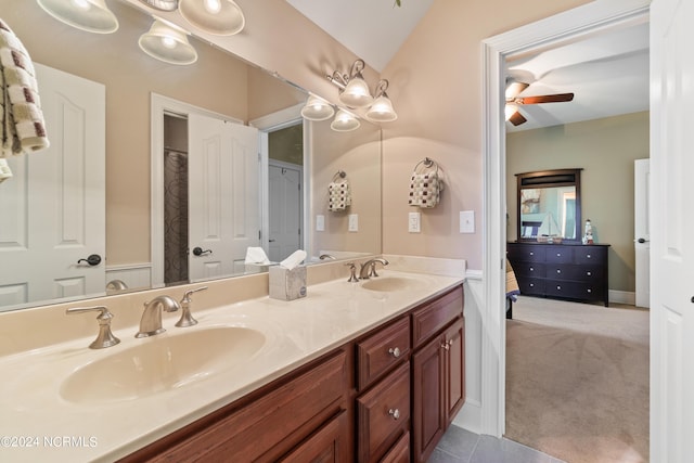 bathroom featuring tile patterned floors, ceiling fan, vanity, and lofted ceiling