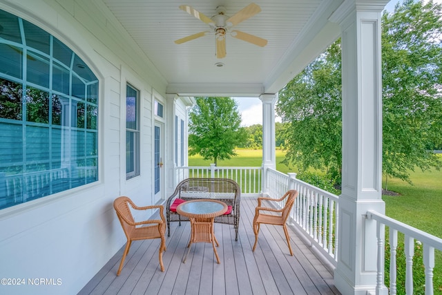 wooden terrace with ceiling fan and a porch