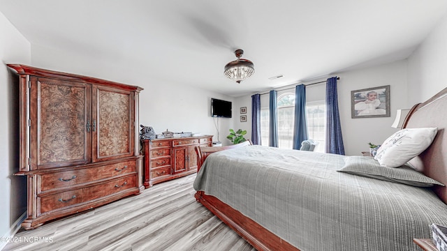 bedroom with light hardwood / wood-style flooring