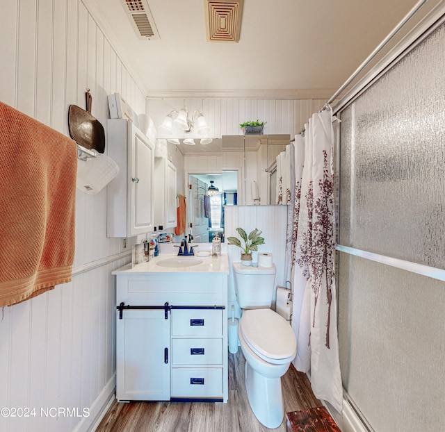 bathroom featuring vanity, wood-type flooring, and toilet