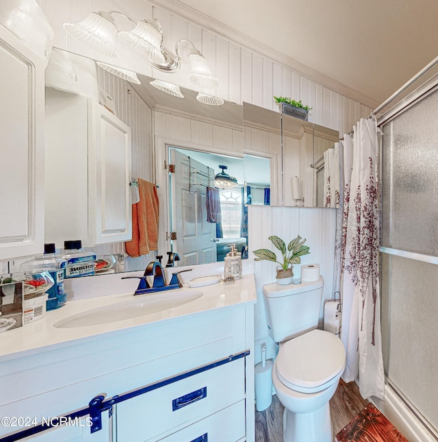 bathroom featuring hardwood / wood-style floors, crown molding, toilet, and vanity