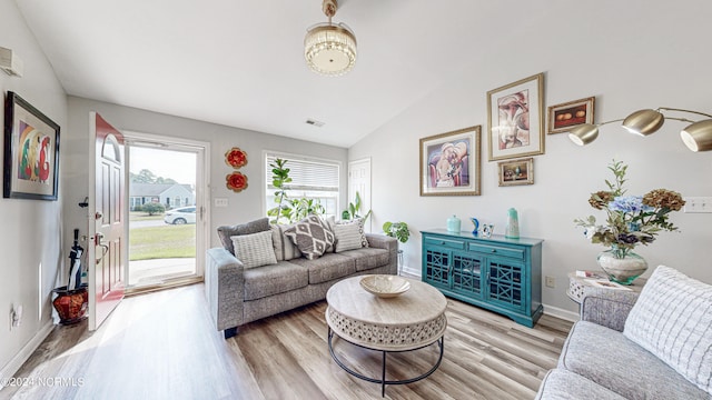 living room with hardwood / wood-style flooring and vaulted ceiling