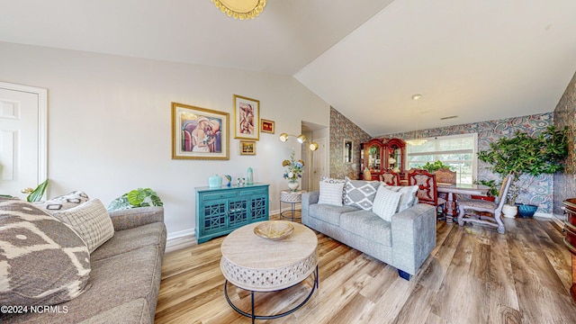 living room with lofted ceiling and hardwood / wood-style floors