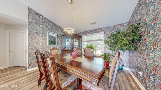 dining space featuring light hardwood / wood-style flooring and lofted ceiling