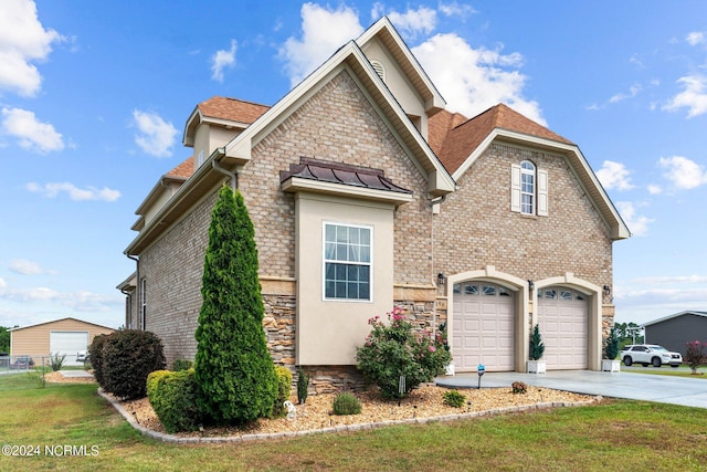 view of property featuring a garage and a front yard