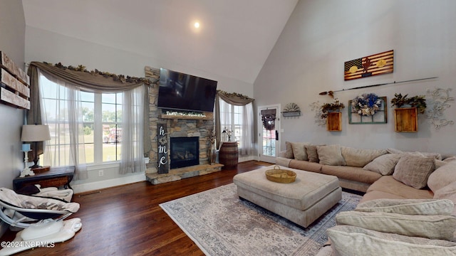 living room featuring high vaulted ceiling, dark hardwood / wood-style floors, and a fireplace