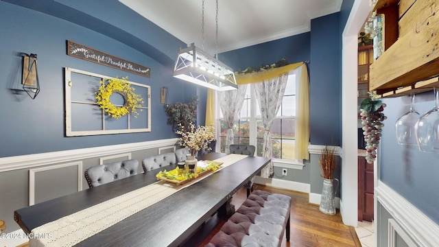 dining room with ornamental molding and hardwood / wood-style floors