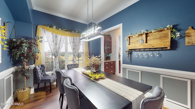 dining space featuring dark wood-type flooring and ornamental molding