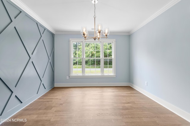 unfurnished dining area with ornamental molding, light hardwood / wood-style flooring, and a chandelier