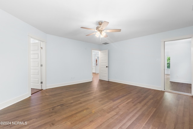 empty room featuring ceiling fan and dark wood-type flooring