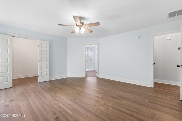 empty room with hardwood / wood-style floors and ceiling fan