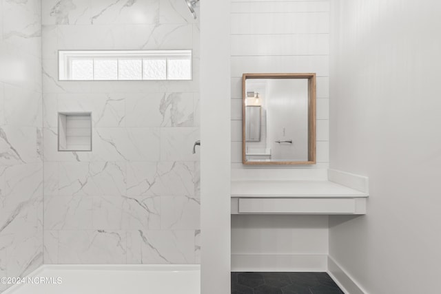 bathroom featuring tile patterned floors and tiled shower