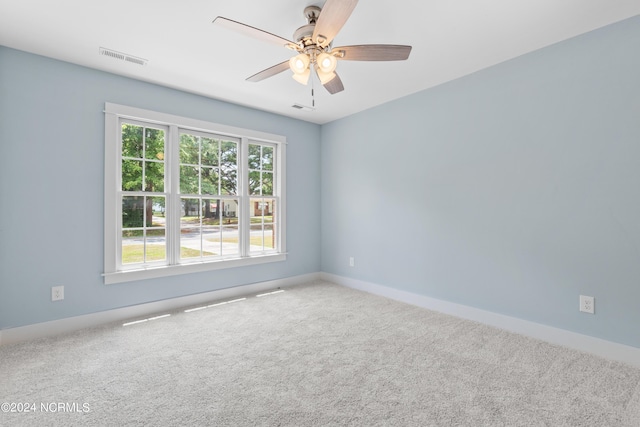 empty room with ceiling fan and carpet