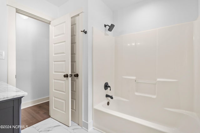 bathroom featuring vanity and  shower combination