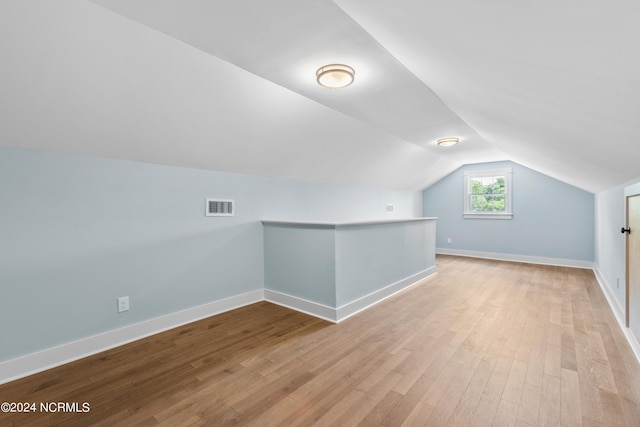 bonus room featuring vaulted ceiling and light hardwood / wood-style flooring