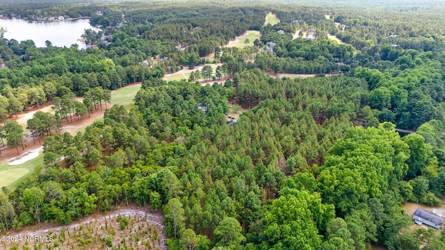 aerial view featuring a water view, view of golf course, and a wooded view