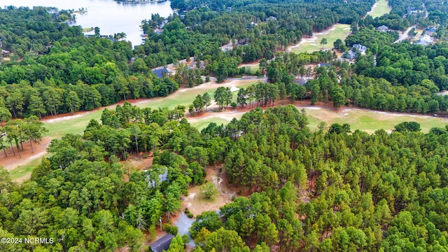 birds eye view of property featuring view of golf course and a forest view