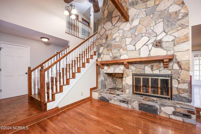 unfurnished living room featuring visible vents, baseboards, a fireplace, and stairway