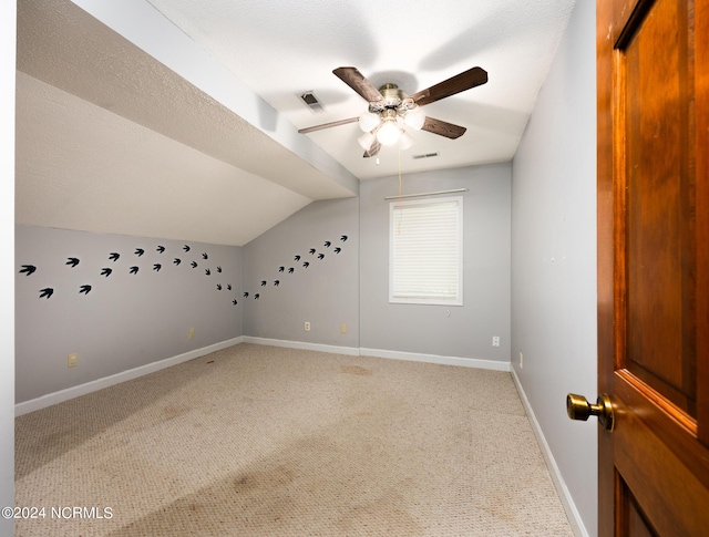 bonus room featuring baseboards, a ceiling fan, light colored carpet, and visible vents