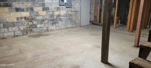 unfinished below grade area featuring concrete block wall
