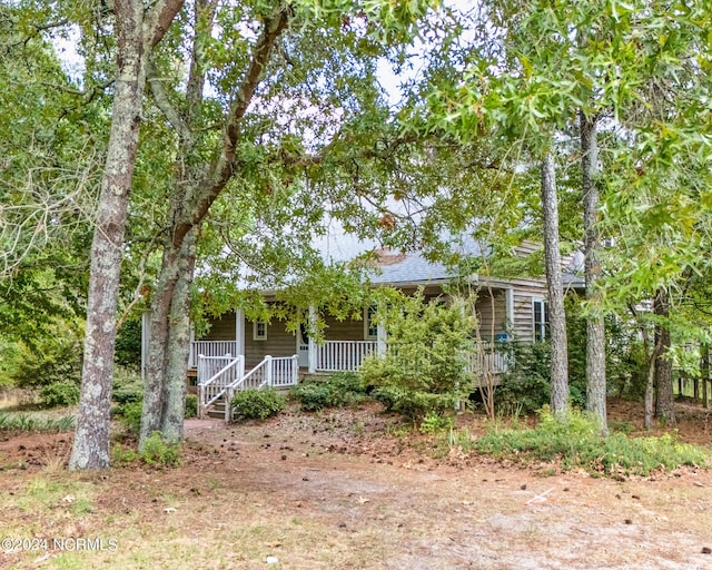 obstructed view of property with covered porch