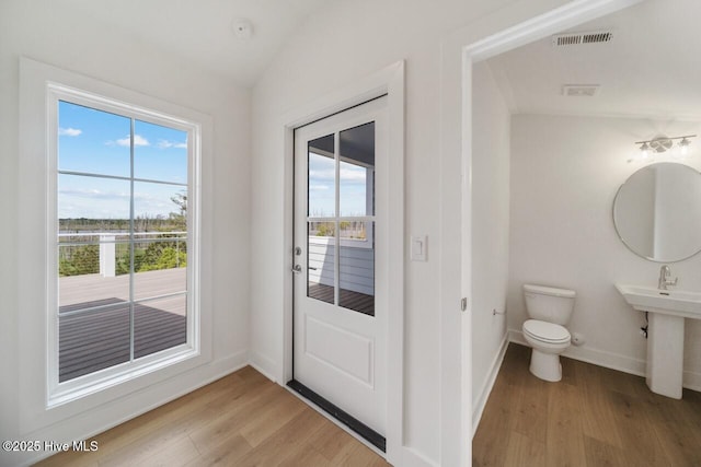 2601 Alvernia Dr, Castle Hayne, NC 28429 - doorway featuring light wood finished floors, baseboards, and lofted ceiling