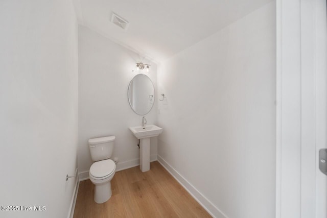 2601 Alvernia Dr, Castle Hayne, NC 28429 - bathroom featuring wood finished floors, toilet, and baseboards