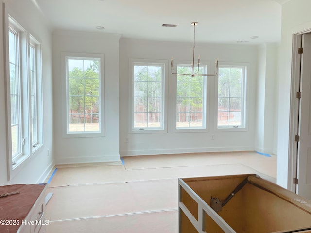 kitchen featuring plenty of natural light and hanging light fixtures