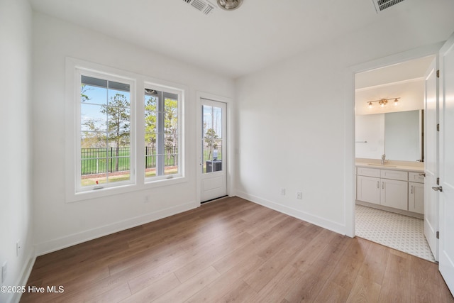 2601 Alvernia Dr, Castle Hayne, NC 28429 - spare room with light wood-style flooring, baseboards, and a sink