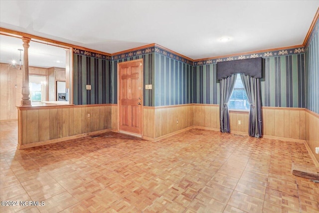 empty room featuring crown molding and light parquet flooring