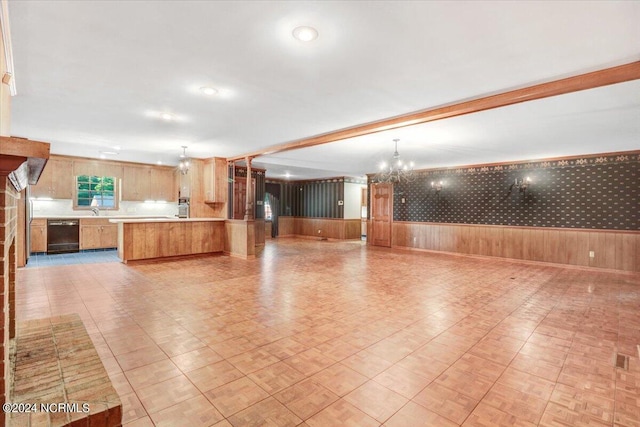 interior space with beamed ceiling, sink, and an inviting chandelier