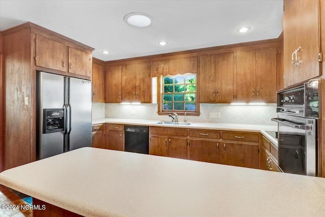 kitchen featuring sink, tasteful backsplash, stainless steel fridge with ice dispenser, black dishwasher, and wall oven