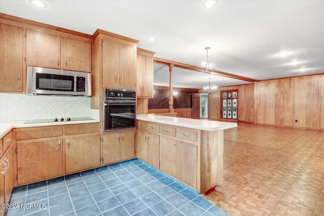 kitchen with tasteful backsplash, decorative light fixtures, a chandelier, kitchen peninsula, and black appliances