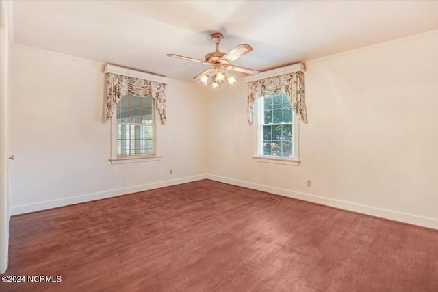 empty room featuring wood-type flooring, ornamental molding, and ceiling fan