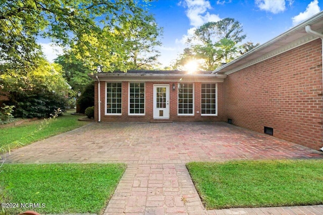 exterior space with a lawn and a patio